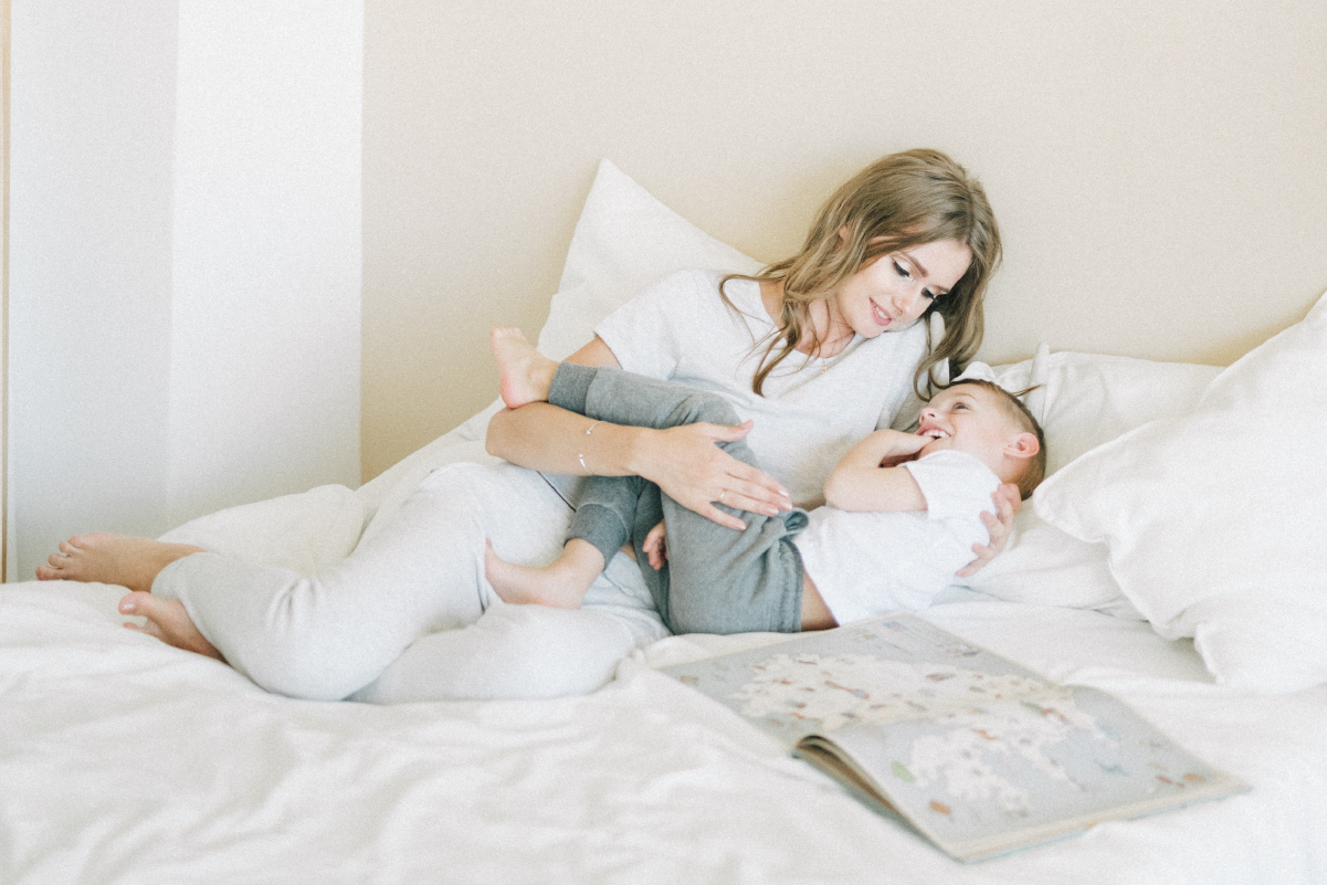 Mom with baby thinking about a telehealth appointment